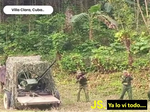The Cuban army preparing to fight off an American invasion, practicing with an anti-aircraft battery mounted on a cart pulled by oxen.