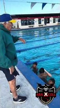 Football Players getting coached by an Olympic Hall Of Fame Swim Coach in the pool