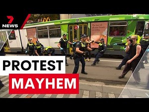 Protesters clash with police and splinter groups in a city showdown over women's rights | 7NEWS