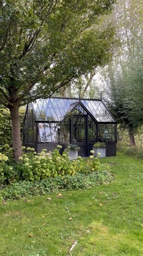 Alitex Glasshouses on Instagram: "For today’s #WainscotWednesday, @nellyatalitex is showing us our Mottisfont greenhouse - displayed on our new Wainscot aluminium base, at our Hampshire show site! Both the greenhouse and the base are finished in the striking colour ‘Bronze Manganese’, creating a seamless, cohesive look. The Wainscot base offers a contemporary alternative to traditional brick or stone foundations. Currently available on our National Trust greenhouses, it allows for faster, more s