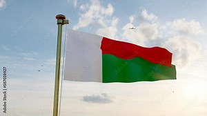 Flag of Madagascar waving in the wind, sky and sun background. Madagascar Flag Video. Realistic Animation, 4K UHD.