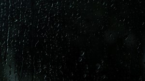 Download Rain drops on the glass. Small raindrop rests on glass while raining. for free