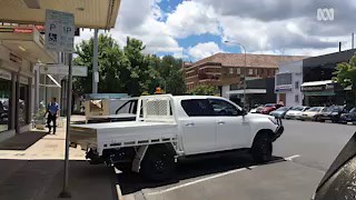 Why do many country towns have reverse angle parking?