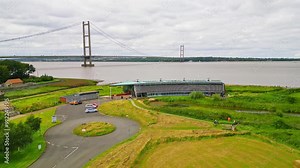 Aerial drone view of Humber Bridge, 12th largest suspension span, gracefully crossing River Humber, connecting Lincolnshire to Humberside with traffic.