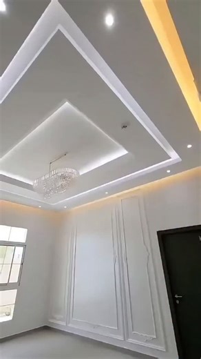 This ceiling's modern design features a unique layered rectangular pattern, comprising a triple-layer rectangle design. The clean drop-down design of the large rectangular boundary and the stepped ceiling created by the inner panel are complemented by a smooth finish and indirect lighting. | Almannan Decor