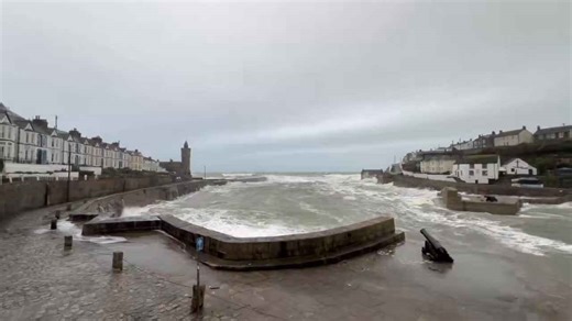 Rough seas and crashing waves hit Porthleven harbour, in Cornwall, England, UK