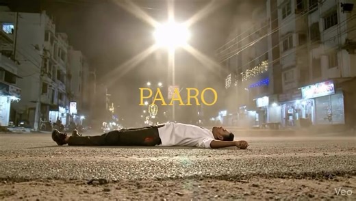 Nighttime cinematic scene filmed from a fixed extreme low-angle SIDE VIEW camera placed directly on an Indian asphalt road. The camera is positioned perpendicular to the road, capturing only left-to-right movement. Strictly side profile view only. No front-facing or head-on shots.