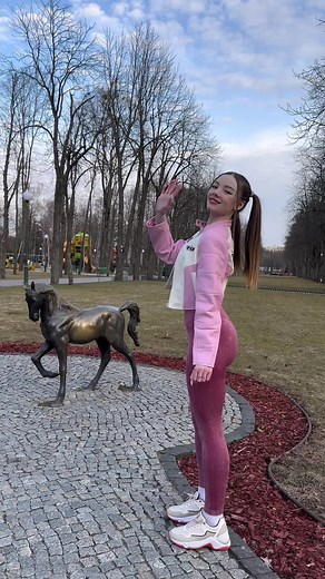 Young Woman Enjoys Park in Pink Outfit