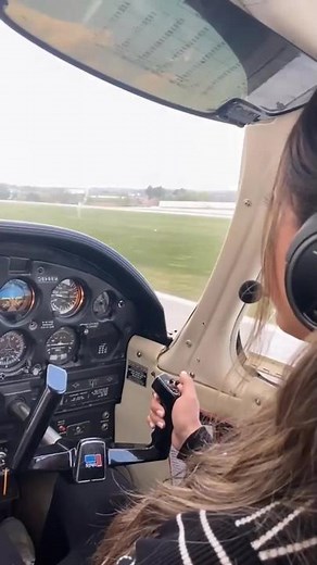 Young Woman Piloting a Small Aircraft in Cockpit