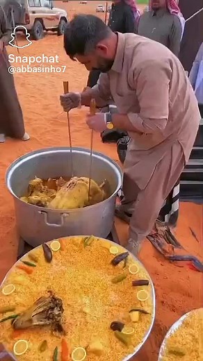 Traditional Rice Dish Preparation with Whole Cooked Fish