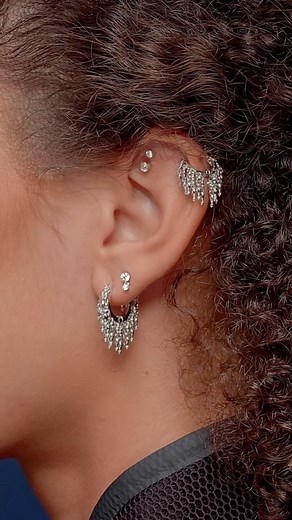 MARIA TASH on Instagram: "Add cascading motion to your curation with our solid gold tassel hoops. Pair our white 14k variety with invisible set diamonds for a crisp, bright look."