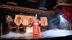 Traditional Chinese opera performance showcasing intricate costumes and elaborate staging in a grand theater setting