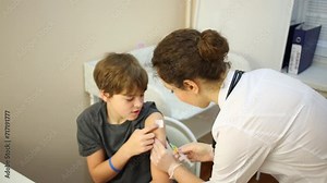 Female doctor prepares arm of boy and makes injection. Stock Video