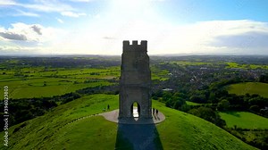 Glastonbury Tor near Glastonbury in the English county of Somerset, topped by the roofless St Michael's Tower, UK