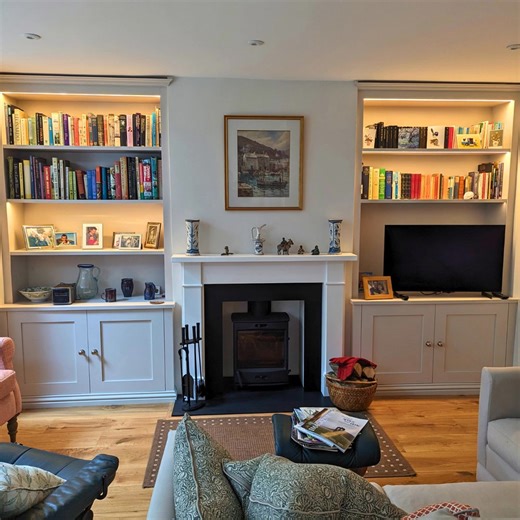 Not just for books. 📚 Here is a quick look at a few different styles of shelving we build. From classic alcove cupboards and shelves around a fireplace to the big corner library with the rolling ladder. A lot more people want LED strip lights. It really changes the feel of the room and turns simple storage into a proper feature. Everything is made to measure in our workshop. Let me know which style you prefer—the classic white or the darker finish? #BespokeJoinery #Bookcases #LibraryDesign #Wok
