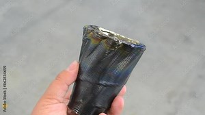 Person holding in hand cup printed by 3D printer from metal. Additive manufacturing solution. Object created on 3Dprinter from melting metal thread. 3D Metal Printing. Metal additive manufacturing