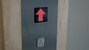 clip-1096213775-man-presses-elevator-button-doors-open-he