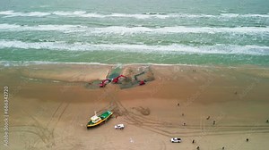 Zandvort, Netherlands 26.11.2023. Rescue of a ship, tug. The ship washed ashore during a large storm in the North Sea. Excavators dig a channel in the sand to pull the ship out to sea.