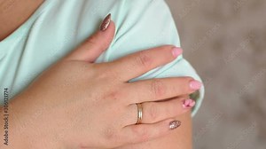 Close-up of the wet sweat stain on the woman's clothes in the armpit. The girl complexes because of sweaty armpits. Slow motion.