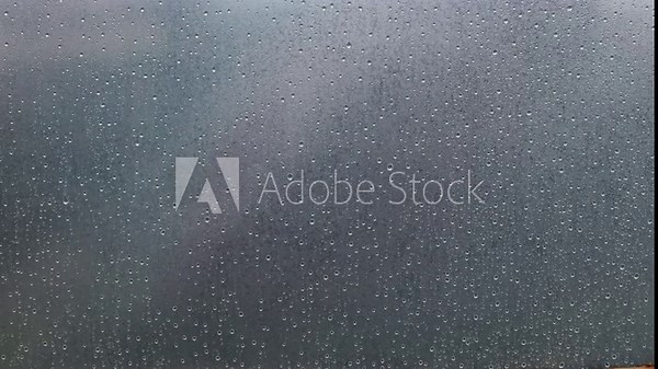 Raindrops on transparent oilcloth. Many drops of water on a transparent background. Condensation in the greenhouse, high humidity