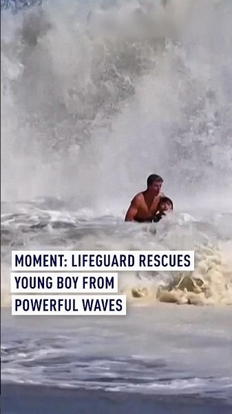 MOMENT: Lifeguard rescues young boy from powerful waves