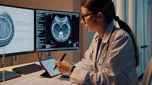 Neurologist reviewing brain MRI on dual monitors at dim workstation, taking handwritten notes on tablet, concentrated atmosphere of study and clinical research with advanced imaging software