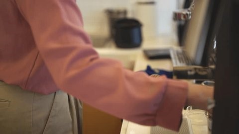 clip-3991750771-person-using-coffee-machine-prepare-espresso-shot