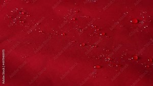 Waterproof textile cloth concept. Rain, water drops are splashing on coat but waterproof is saving from be wet.