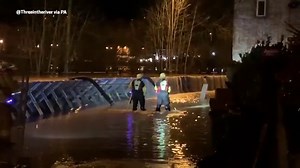 Water pours over flood defences in Bewdley, Worcestershire