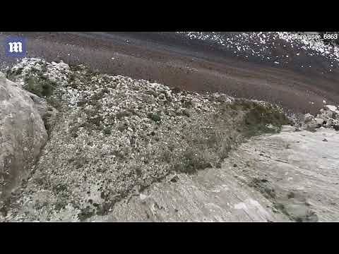 Base jumper SMASHES into rocky beach in near fatal accident!