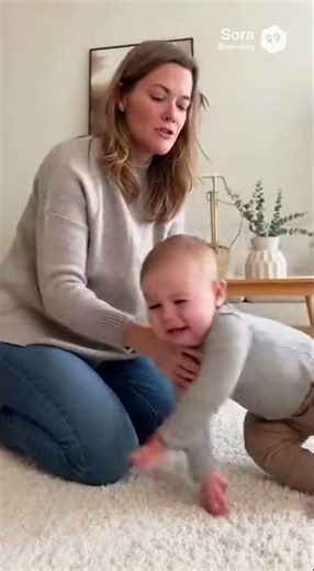 funny babby palying with cat