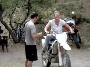 women trying to start motorcycle