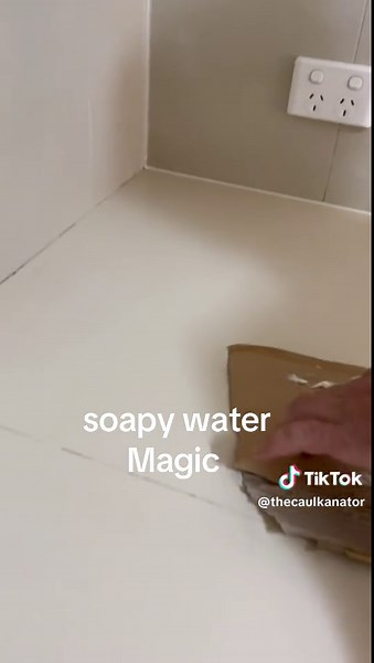 always apply your silicone before using soapy water magic.#fyp #caulkantor #soapywater #satisfying #australia #silicone #kitchen #stone #sink #tiles