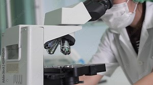 A laboratory technician makes microscopic bacteriological examination with the reagents. Work in micro laboratory.