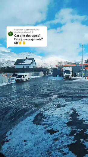 Snowy Urban Scene with Vehicles and Scenic Mountains