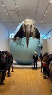 A stunning fantasy scene ✨A giant elephant slowly hatching from a massive egg