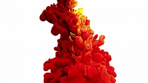 Red, yellow and green ink splash in water on white background