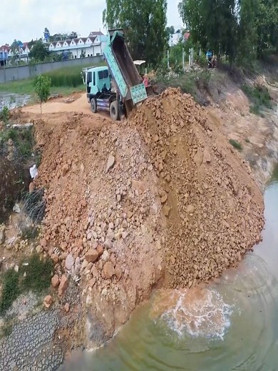 31K views · 357 reactions | Fantastic Work! D20P Dozer Pushing Stones While Dump Trucks Unload Into the Deep Pond | Sova | Facebook