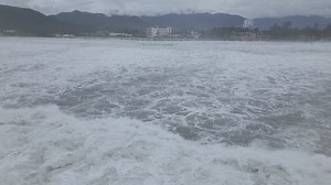 Storm surge waves are one of the greatest coastal hazards associated with landfalling typhoons - they can seemingly appear out of nowhere, catch people off guard and sweep away vehicles and buildings. But what makes them stand apart from the waves you see on a regular day at the beach? Storm surge waves carry a tremendous amount of mass and momentum. When a typhoon moves towards the coast the sea level rises, in part due to the low pressure imparting less force on the ocean surface, but mostly d