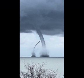Twin waterspout tornadoes intersect off the coast of Italy