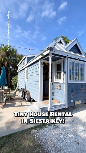 Would you stay in the "Pina Colada" tiny house rental in Siesta Key, Florida for a weekend? Inside, this tiny house features a small living space with a couch, a kitchen with apartment-size appliances, a closet, a bathroom, a main-floor bedroom, & a bonus loft bedroom--sleeps a total of 3 people! Located at Tiny House Siesta & built by Tumbleweed Tiny House Company 🏡 #tinyhouse #tinyhome #bungalow #cottage #siestakey | Dream Big Live Tiny Co.