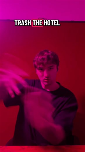 Fancy by @Iggy Azalea #ASL #ASLMUSIC #ASLInterpreting #HEARING #DONOTLEARNFROMME [visual description: white hearing male with maroon curly short hair, brown eyes, brown stubble facial hair, wearing a black cru-neck with tattoos on arms hands and fingers, in a white room with green screen using sassy pink lighting filter.] English: Trash the hotel, let’s get drunk at the mini bar, make the phone call, it feels so good getting what I want ASL: HOTEL ROOM DESTROY/MESS-UP CL:5B”take shots on table” 