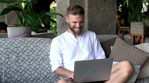 Successful male graphic designer celebrating online goal with web projecting using media application on modern laptop computer, happy IT professional with satisfied with received news on netbook