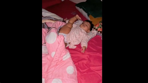 The baby sleeps in a very unusual position with her leg up!