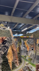 Watch #modeltrain running on the this incredible bridge at #Northlandz – the Model #RailroadMuseum 🚂 Every curve, tunnel, and bridge is built with incredible detail and artistry that brings this miniature world to life. ✨🎟️ Visit us in #Flemington, NJ, and explore 8 miles of track, breathtaking #bridges, and jaw dropping #landscapes that every train lover dreams of! #Northlandz #ModelRailroadMuseum #thingstodonj #ModelTrains #MiniatureWonderland | Northlandz Miniature Wonderland & Train Museum