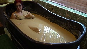 Woman relaxes in the mud bath