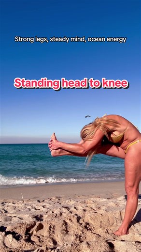 Standing head-to-knee on the sand, finding balance where the earth meets the sea. Not perfect, just present, grounded, and breathing it all in. #beachyoga #balancepractice #strongandcalm #yogalifestyle #oceanenergy