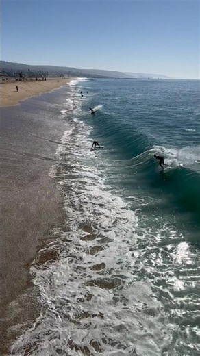How many skimboarders would fit in this wave?