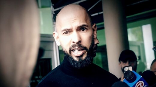 Andrew Tate, charged with rape and trafficking in Romania, returns to the U.S.