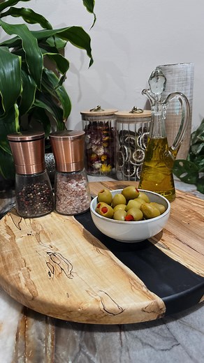 The Resinwood Collection - Blackwater Turntable Locally handcrafted from wood and resin, each 15” turntable is a true one-of-a-kind art piece, measuring a sturdy 7/8” thick. This design features ambrosia maple paired with a live-edge pour of deep black resin, creating a bold, high-contrast composition. The natural patterns of the maple and the sleek, fluid resin blend into a striking, organic statement piece that stands out in any space. $120 Interested in a custom wood or resin design? Let’s br